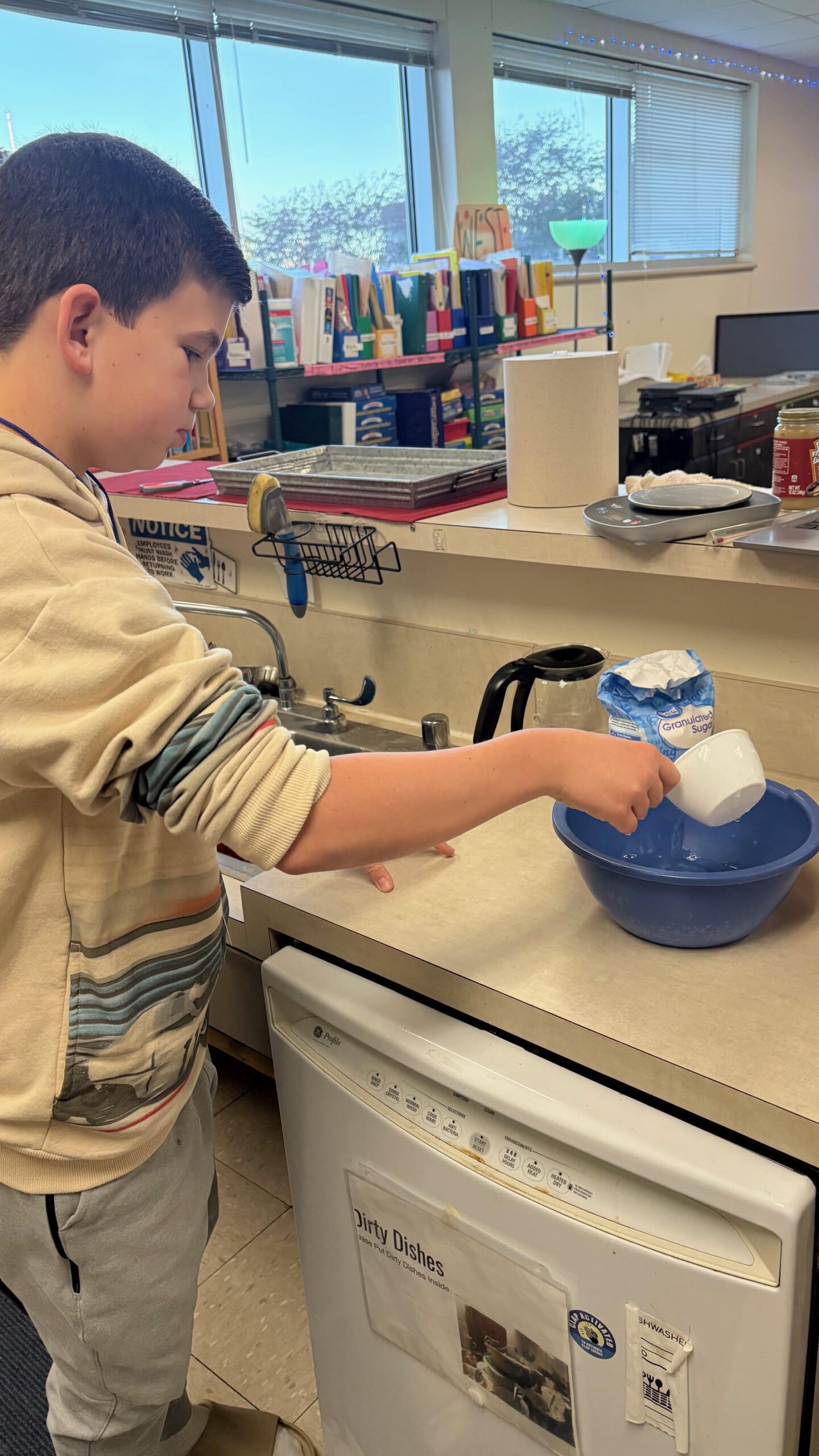 A baker pours sugar into a bowl.
